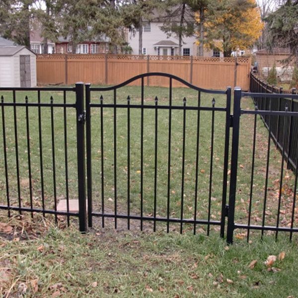 Black aluminum fence on grassy property